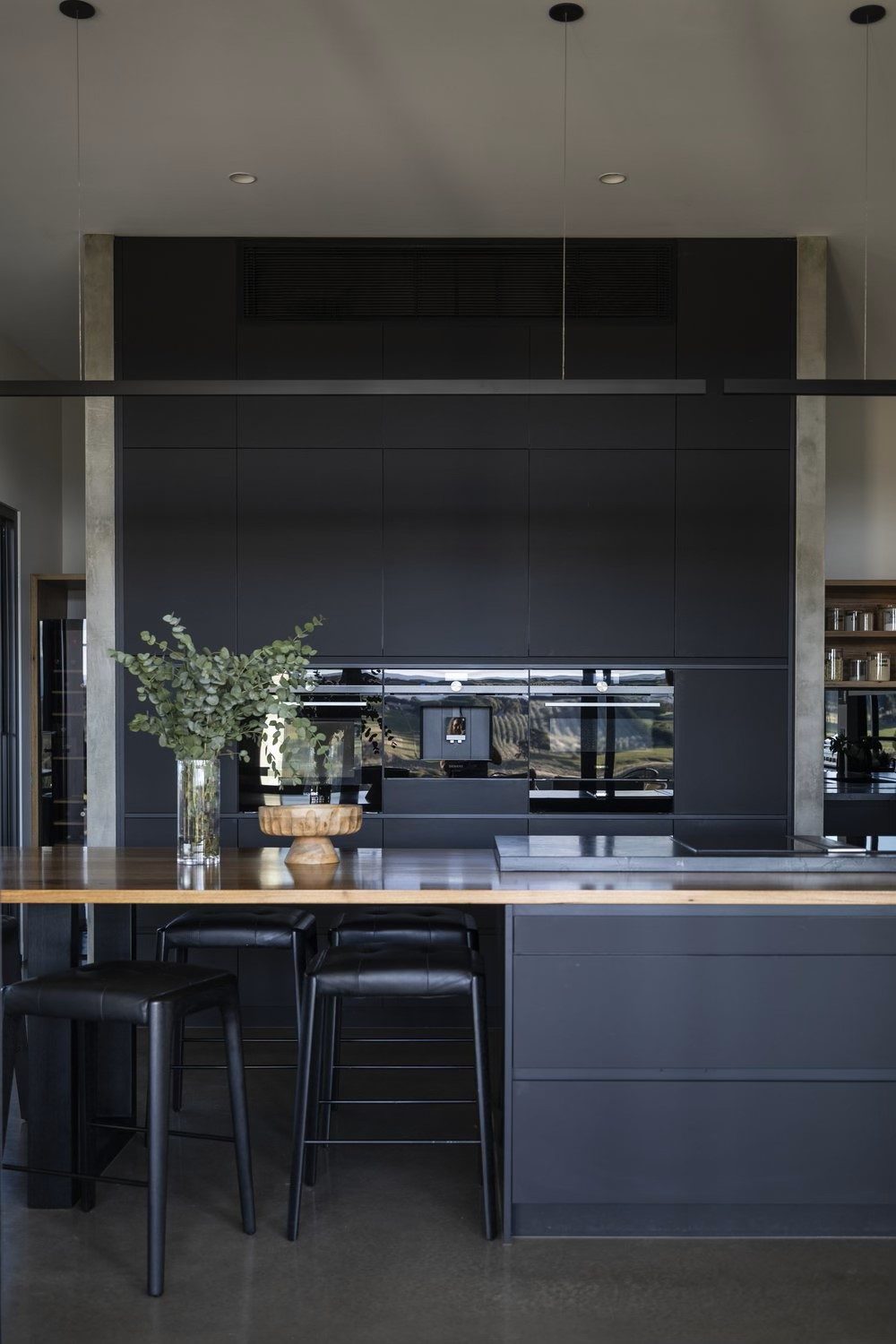 Dark charcoal kitchen with timber island bench — Australian custom cabinetry
