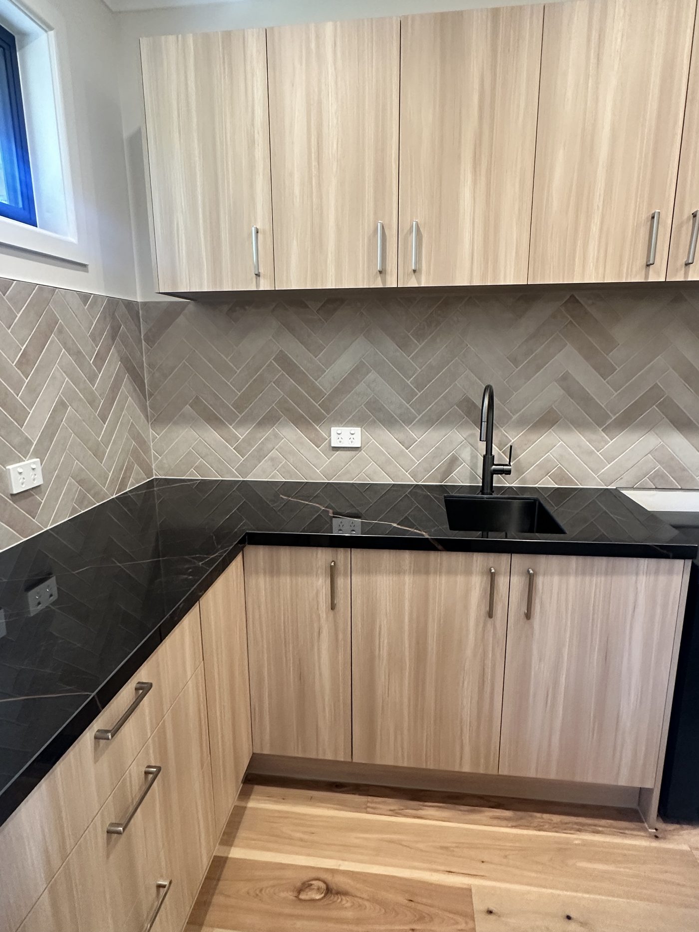Timber kitchen with herringbone tile